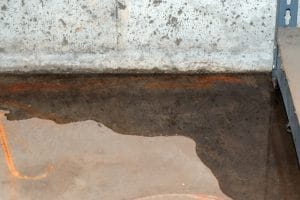 A basement leak from the foundation with standing water