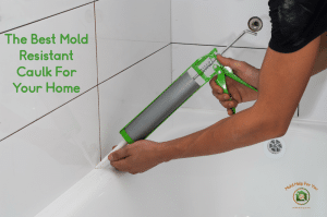 A handyman using mold resistant bathroom caulk around the shower