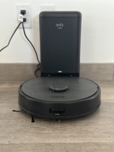 the eufy Clean X8 Pro roboto vacuum on a tile floor against a white wall